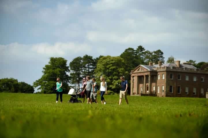 Group of visitors in the grounds of Berrington Hall, Herefordshire.