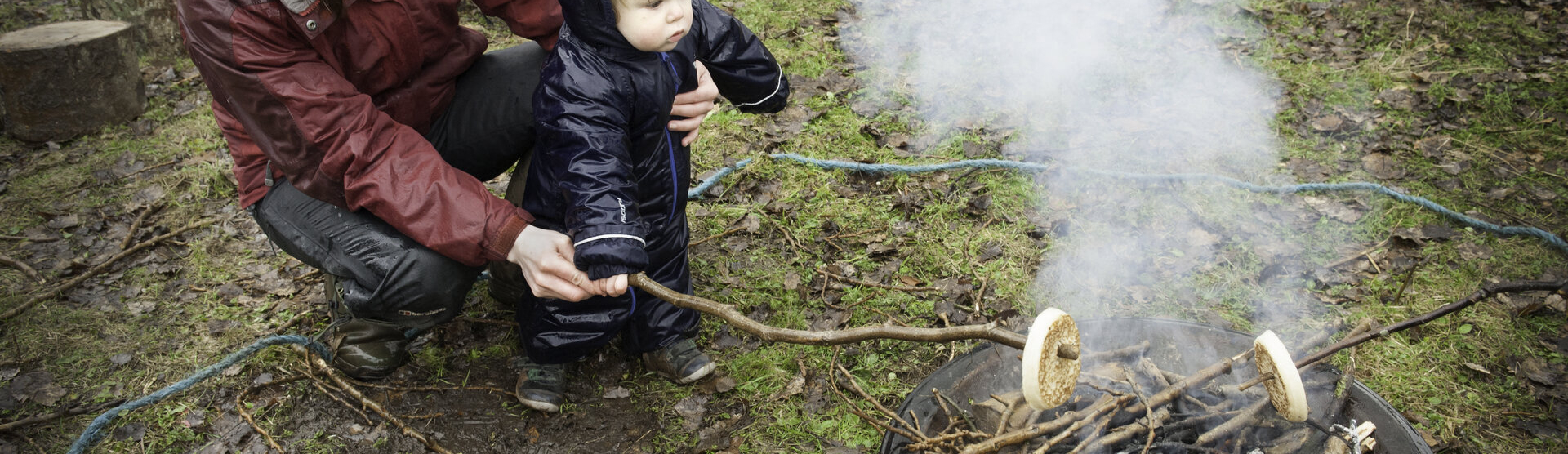 Woman20toddler20food20campfire28c20Susan Freeman