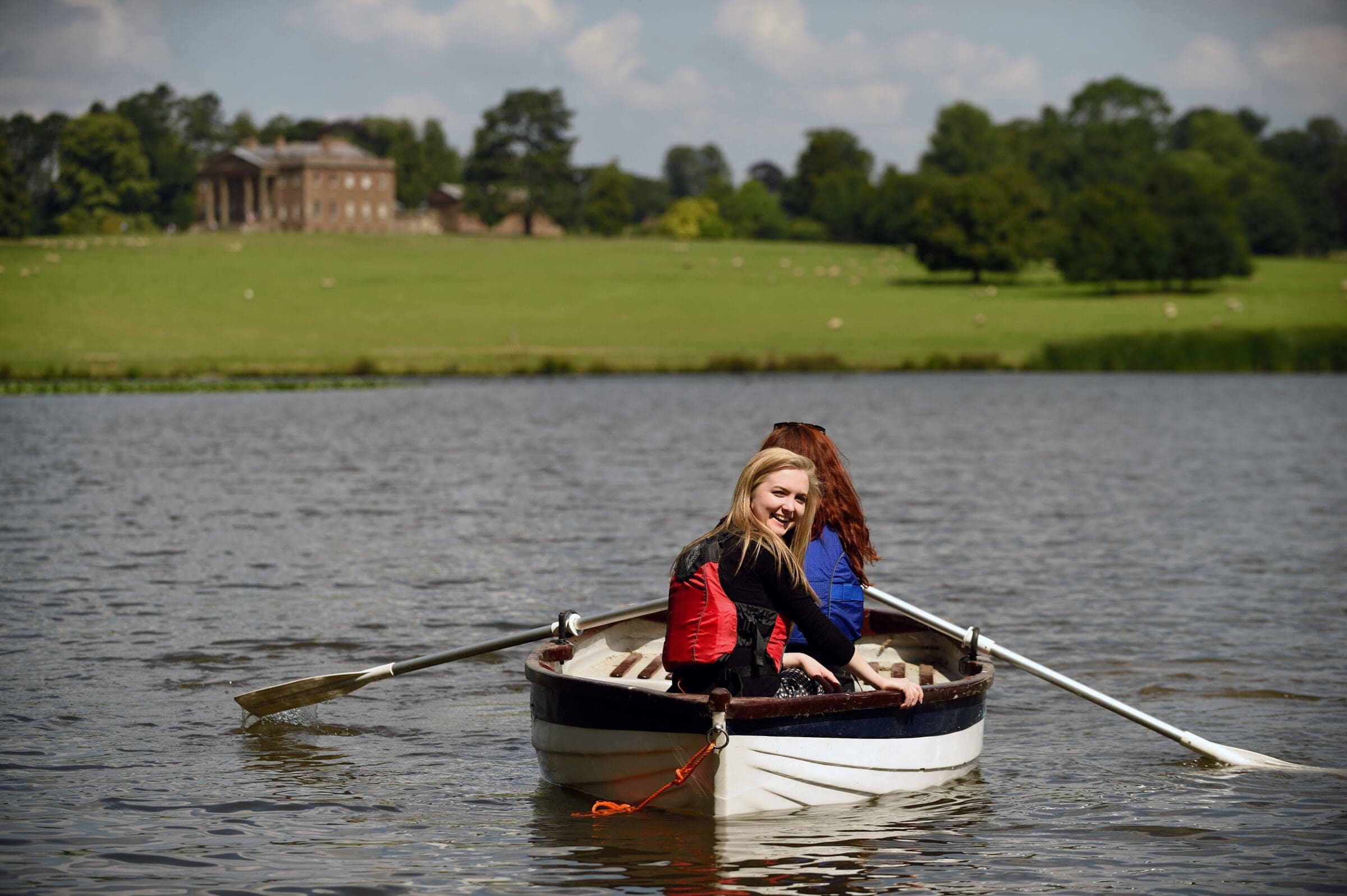 Visitors in a rowing boat on Berrington Pool, Berrington Hall, Herefordshire.